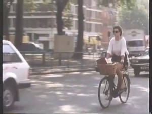 Woman cycling around Shepherds Bush Green - lovely practical bike!